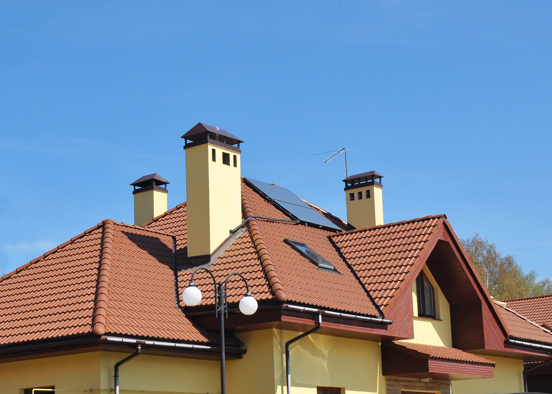 Closeup of solar panel on red tiled house roof